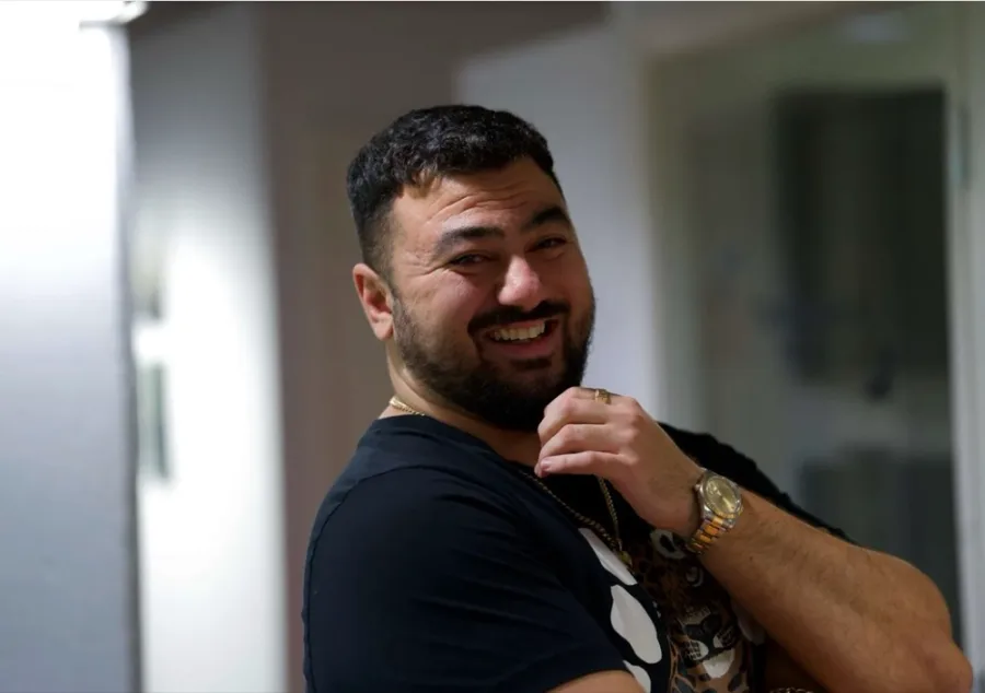 Timo Avdo, photographed for Kauppalehti, turning to the camera and laughing.